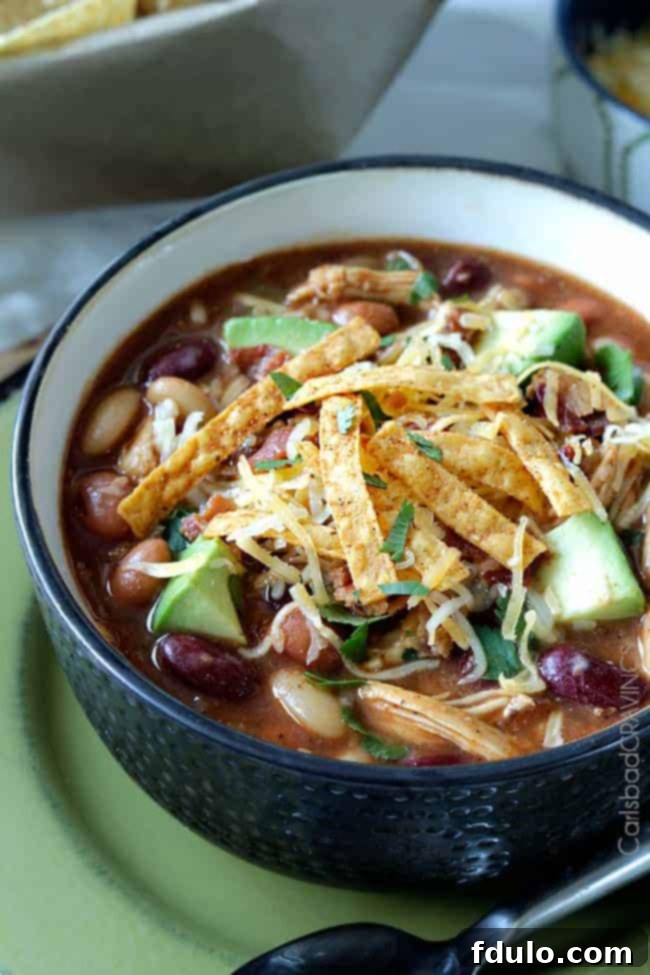 A hearty bowl of smoky BBQ Chicken Chili, ideal for a warm meal before heading out for trick-or-treating.
