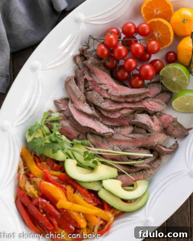 Sizzling Flank Steak Fajitas 3 Easy Steak Fajitas Recipe and toppings from above on a white tray