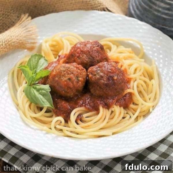 Classic Italian Meat Sauce served in a pristine white bowl, elegantly garnished with fresh basil leaves, ready to be enjoyed.