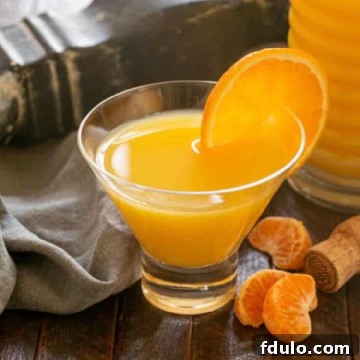 The Grand Mimosa 6 Grand Mimosa with an orange garnish in a Viski glass.