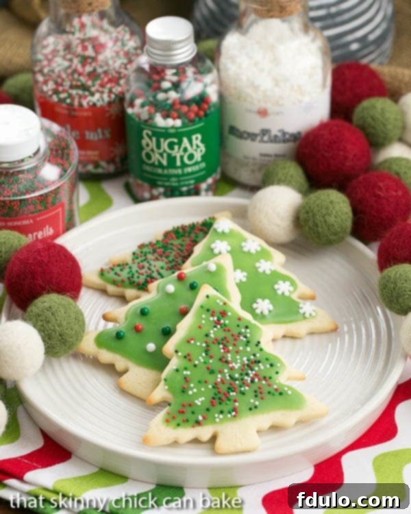 Best Sugar Cookies frosted and beautifully decorated on a white plate.