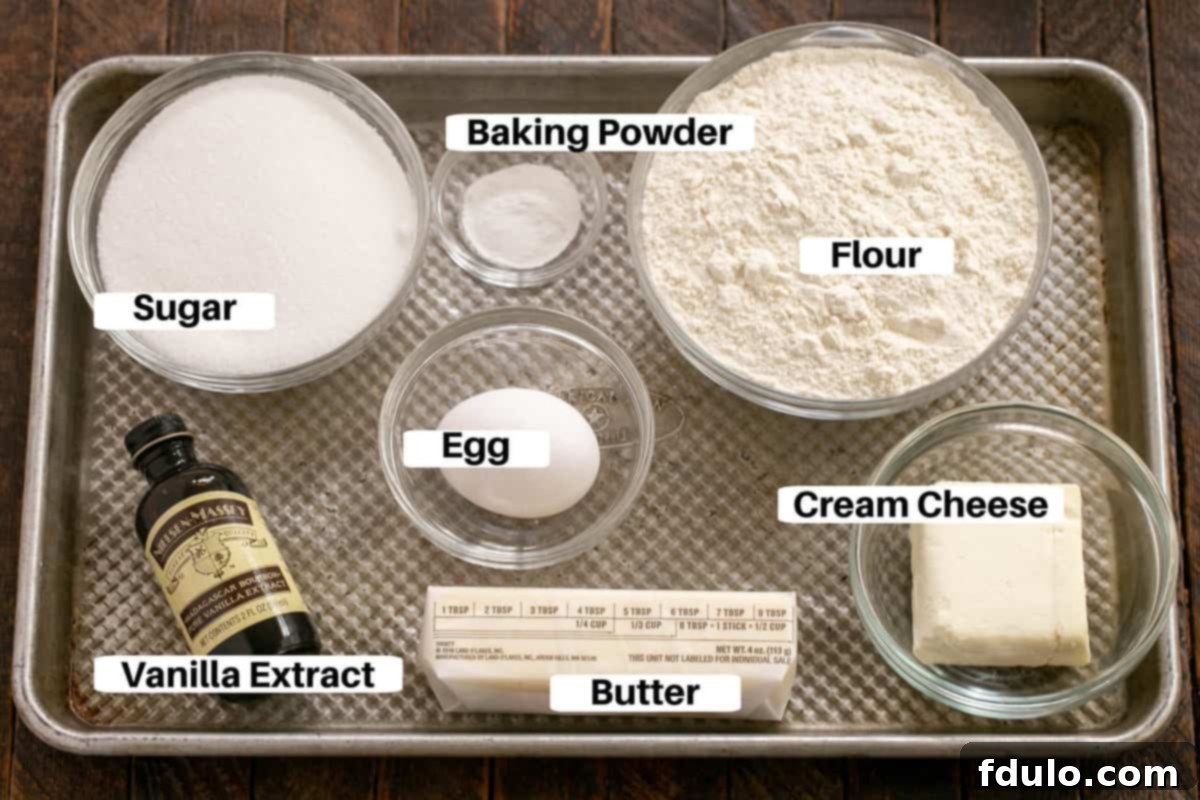 Sugar Cookie Ingredients with labels laid out on a metal sheet pan, ready for baking.