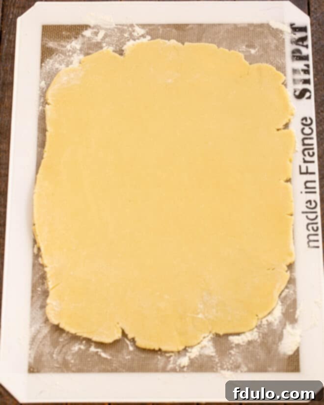 Dough rolled out evenly on a Silpat mat, ready for cutting.