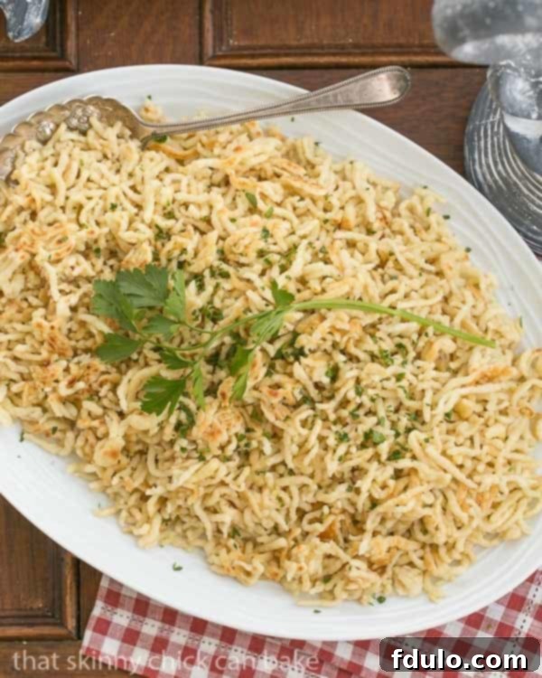 A platter full of homemade spatzle, garnished and ready to be served.