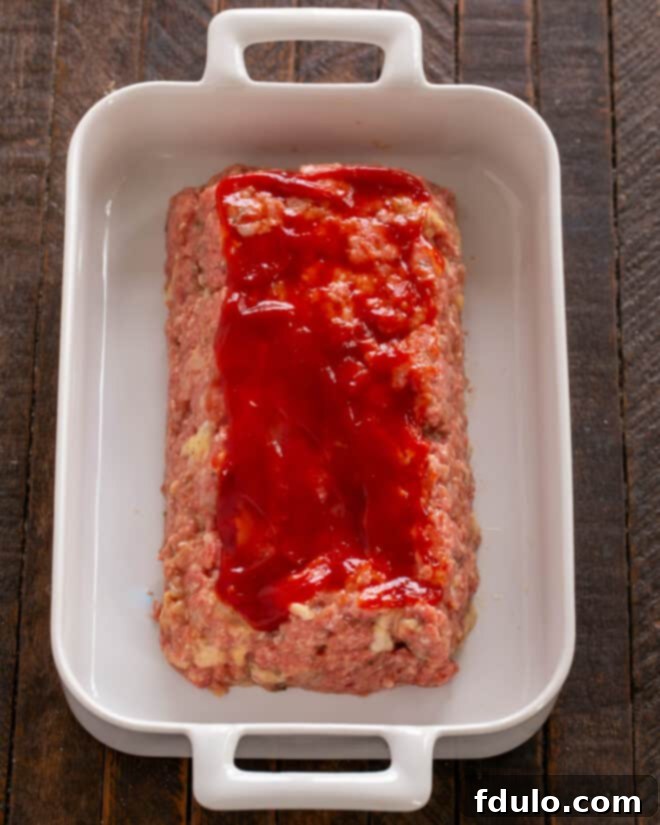 Meat shaped into a loaf and coated with ketchup.