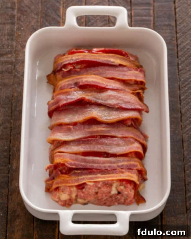 Meatloaf covered with par-cooked bacon.