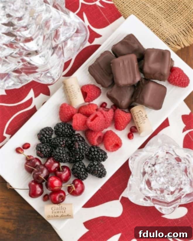 Overhead view of Chocolate Dipped Cheesecake Bites with fruit