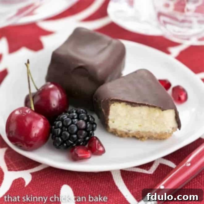 Chocolate Dipped Cheesecake Bites on a small white dessert plate