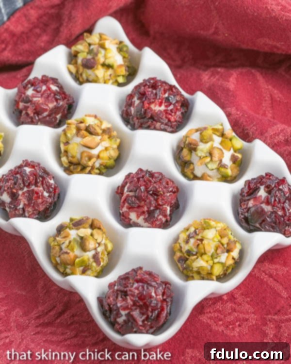 Festive Blue Cheese Balls beautifully arranged in a white ceramic dish on a vibrant red napkin, highlighting their holiday appeal.