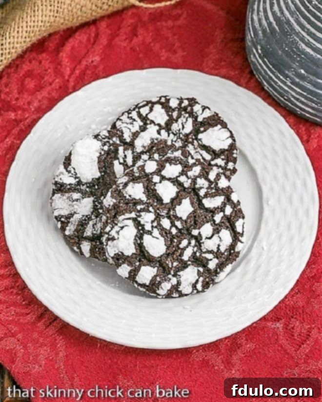 Three Chocolate Crinkles displayed on a white basketweave plate over a festive red napkin