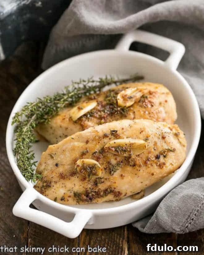Maple Mustard Glazed Chicken Breasts in a white baking dish, ready to be served