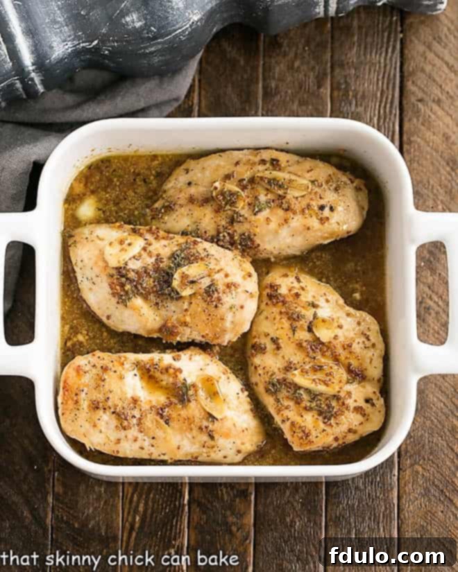 Perfectly cooked Maple Mustard Chicken Breasts nestled in a baking dish