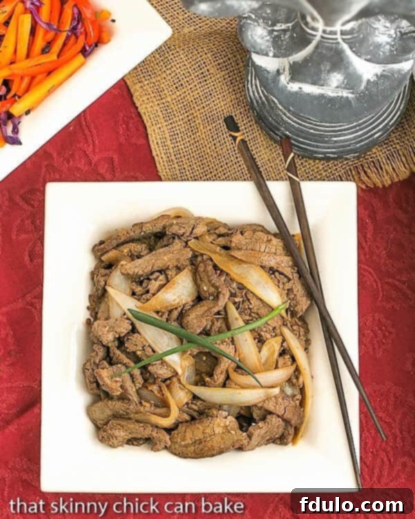Beef Bulgogi on a square white plate with chopsticks and green onions
