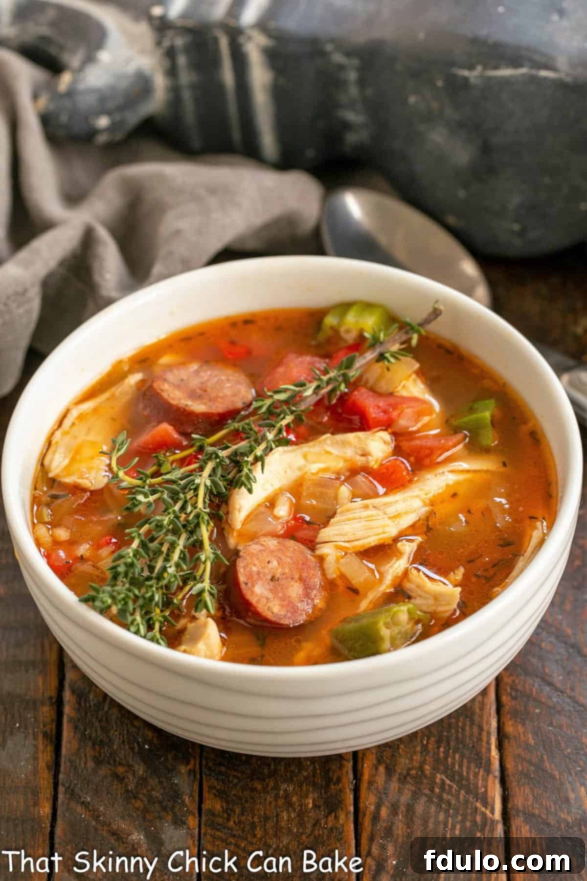 A vibrant bowl of Chicken Jambalaya soup, richly colored and garnished, ready to be enjoyed.