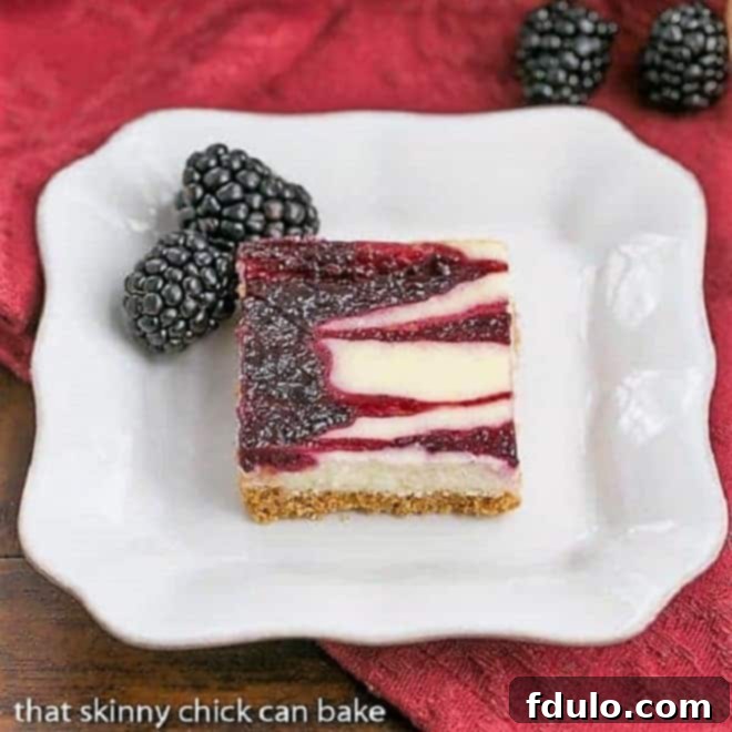 Blackberry Cheesecake Bars - Sublime cheesecake bars with swirls of blackberry jelly A single Blackberry Swirl Cheesecake Bar presented elegantly on a square white plate, showcasing its creamy texture and beautiful fruit swirl.