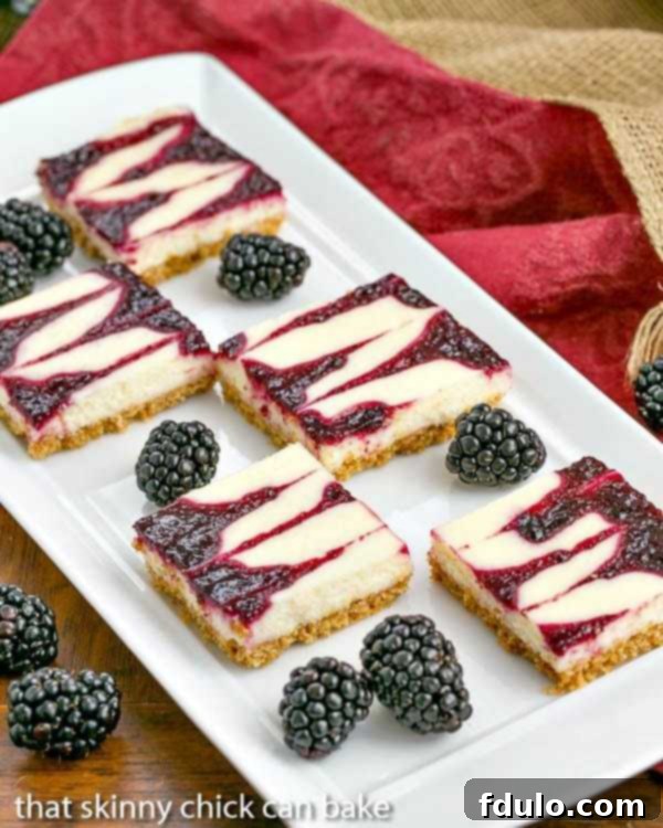 Marbled Blackberry Cheesecake Delights 2 Blackberry Cheesecake Bars | Sublime cheesecake bars with swirls of blackberry jelly