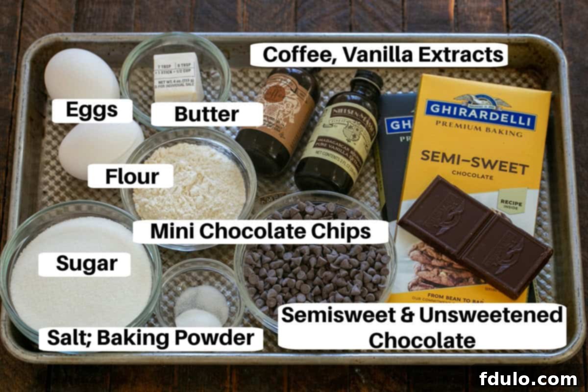 Close-up view of all ingredients for Chocolate Brownie Cookies laid out with labels on a metal sheet pan.