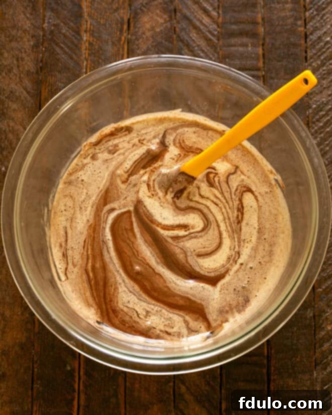 Step 3: Carefully fold the melted chocolate into the egg mixture.