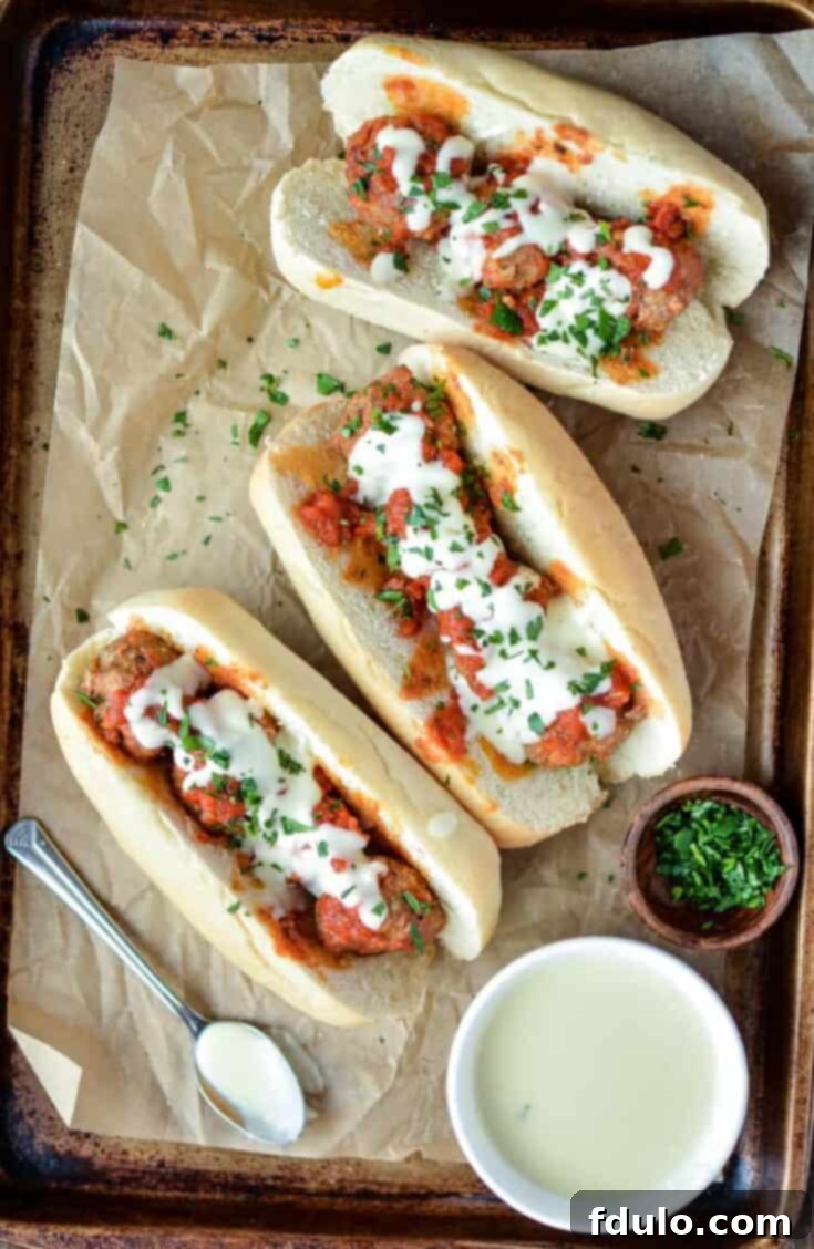 Slow Cooker Meatball Subs with Parmesan and White Cheddar Queso