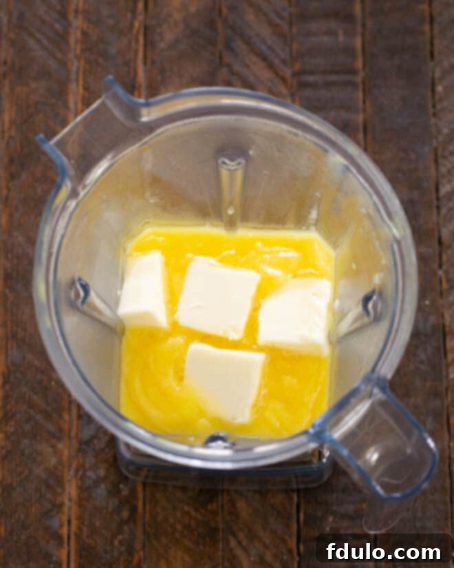 Step 8: Add room temperature butter to the blender mixture a little at a time, blending until smooth.