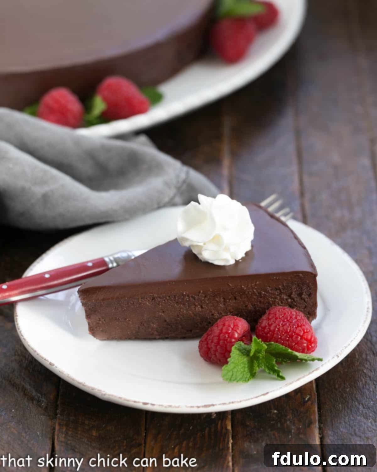 The Black Beast - dark, decadent and possibly the best chocolate cake recipe around! It's out of this world delicious! Slice of la bete noire with a dollop of whipped cream.