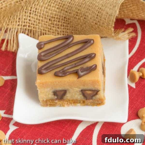 Peanut Butter Cheesecake Bars | Incredibly rich and filled with mini Reese's!