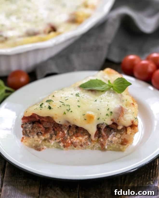 An elegantly plated slice of spaghetti pie, generously topped with a fresh sprig of vibrant basil for garnish, presented on a pristine white plate against a softly blurred background, inviting appreciation and culinary delight.