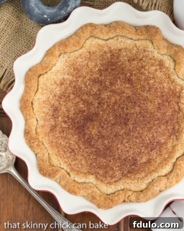 Hoosier Sugar Cream Pie in a red and white ceramic pie plate from above, showcasing its golden top.