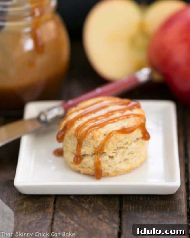 One Caramel Apple Scone on a square white platae with a red handled knife