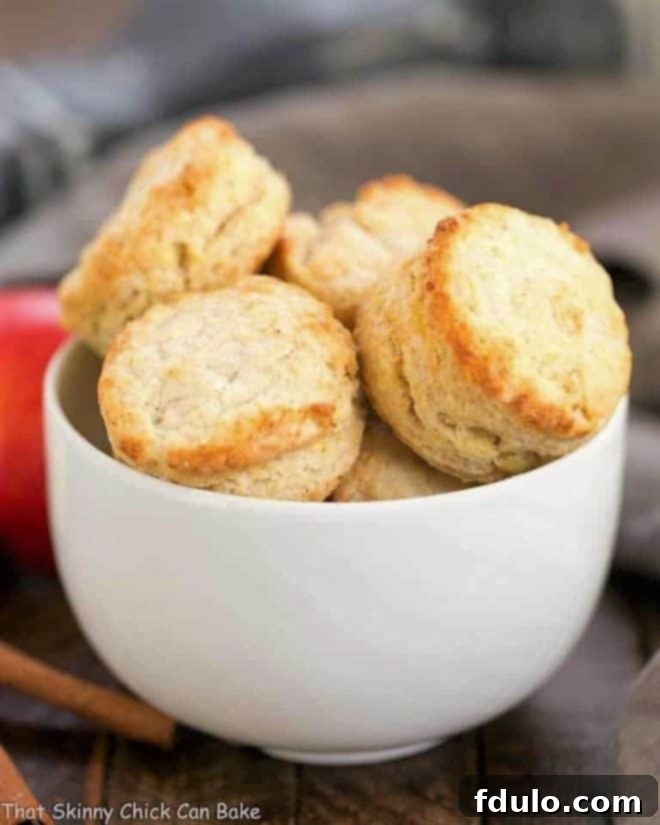 A white ceramic bowl filled with round Caramel Apple Scones 