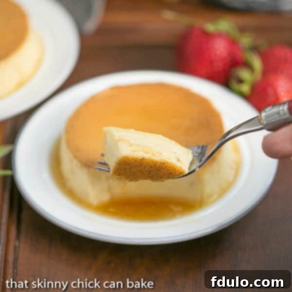 Mini Vanilla Flans - The classic Spanish custard and caramel dessert in individual servings! Forkful of mini vanilla flans with mini flan on a white plate in the background.