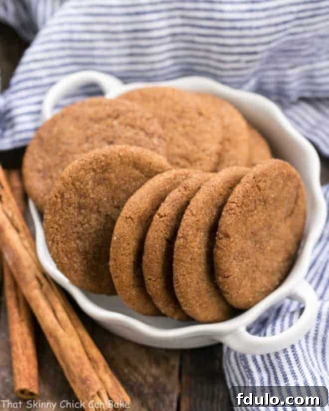 Delicious Holiday Ginger Crisps elegantly displayed in a white terrine, garnished with fragrant cinnamon sticks, ready for festive gatherings