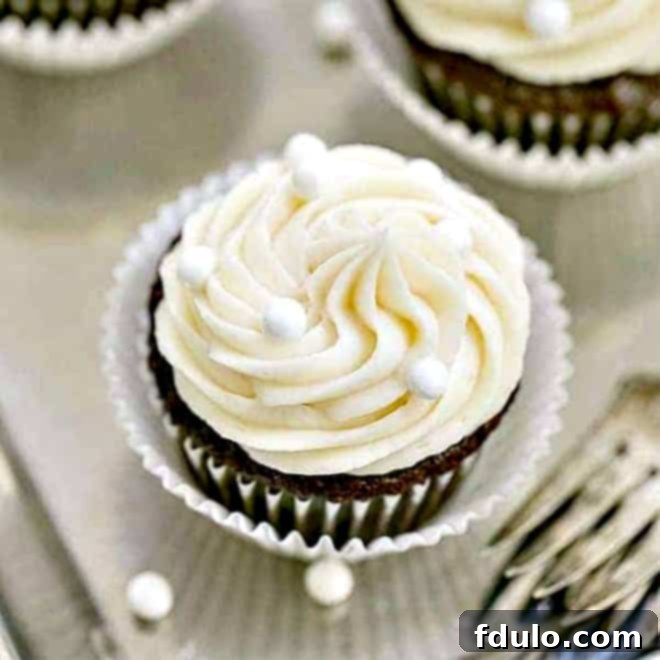 Delicious Vanilla Buttercream Topped Cocoa Cupcakes on a silver tray, ready to be enjoyed.