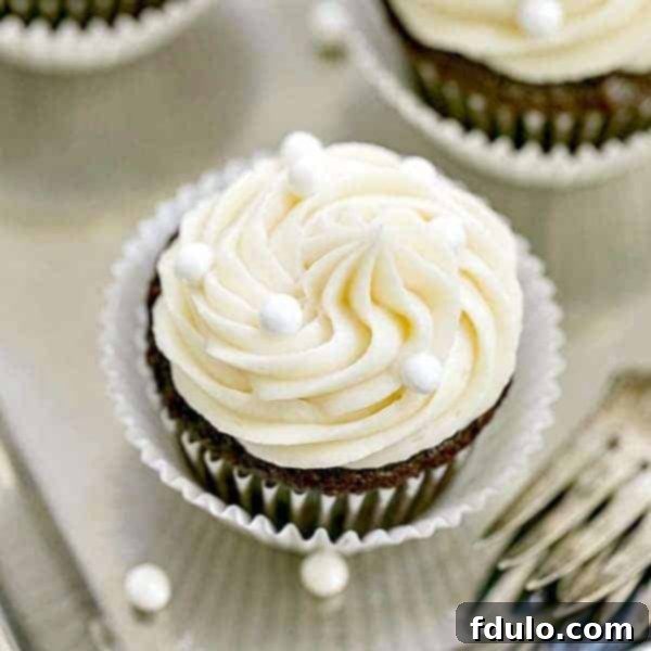Vanilla Buttercream Topped Cocoa Cupcakes | Moist, scrumptious chocolate cupcakes topped with a mound of vanilla buttercream