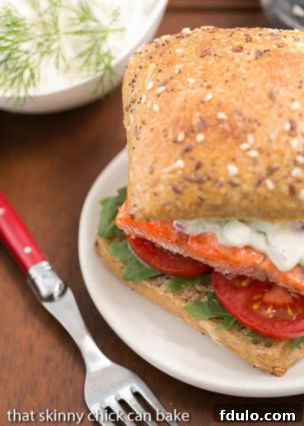 Open-Faced Salmon Sandwich with Herb Cucumber Relish on a round white plate.