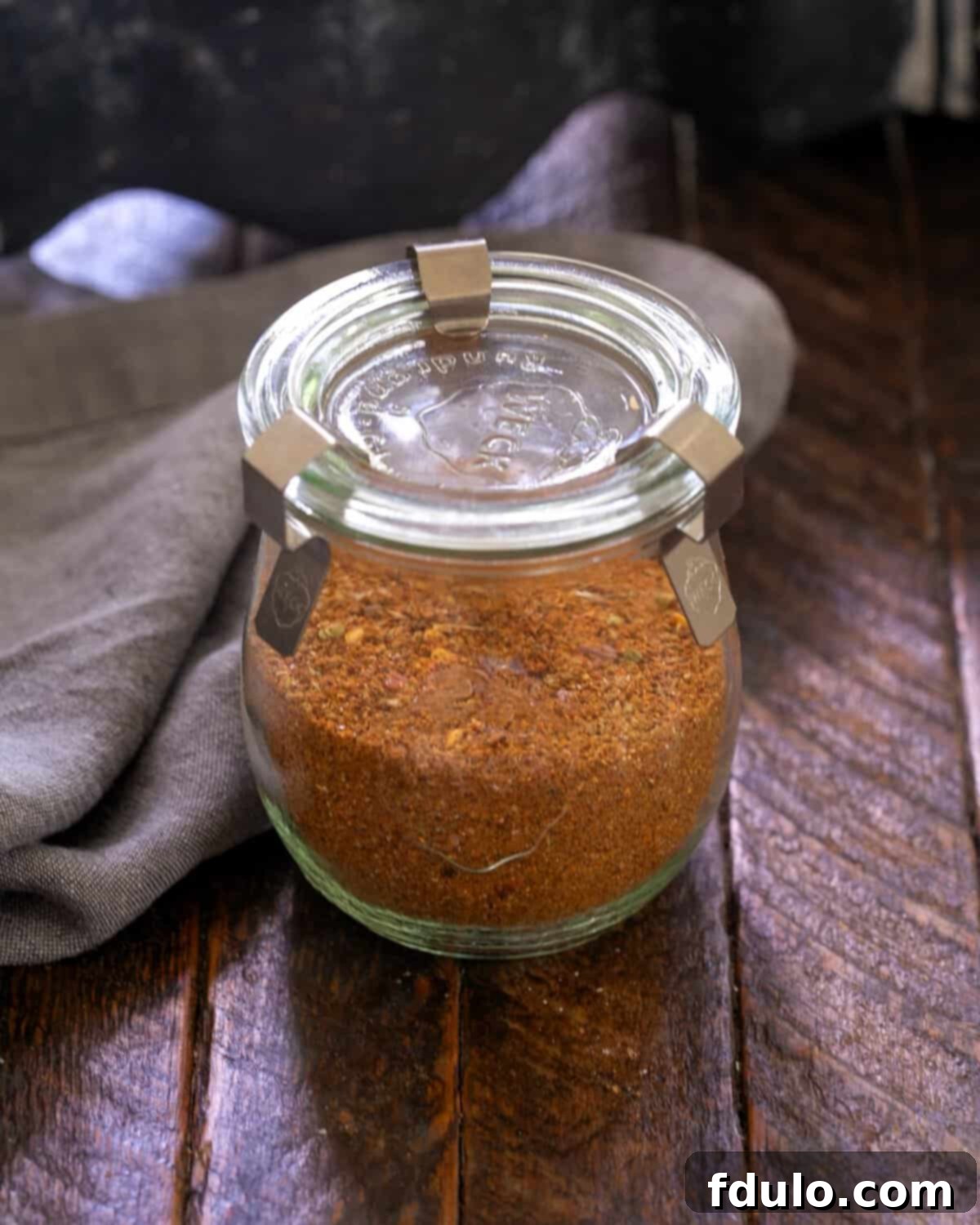 Taco seasoning in a beautiful glass storage container, ready to be used in various dishes.
