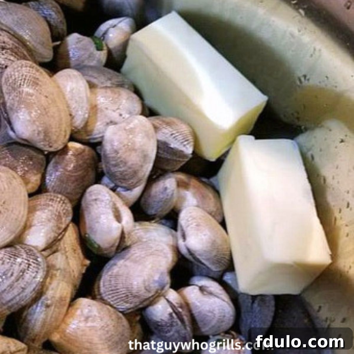 Clams in stock pot with butter sticks before cooking