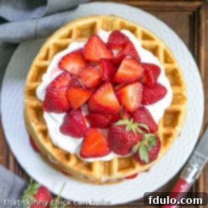 Strawberry Waffle Cake, a layered dessert with cake batter waffles, fresh strawberries, and whipped cream.