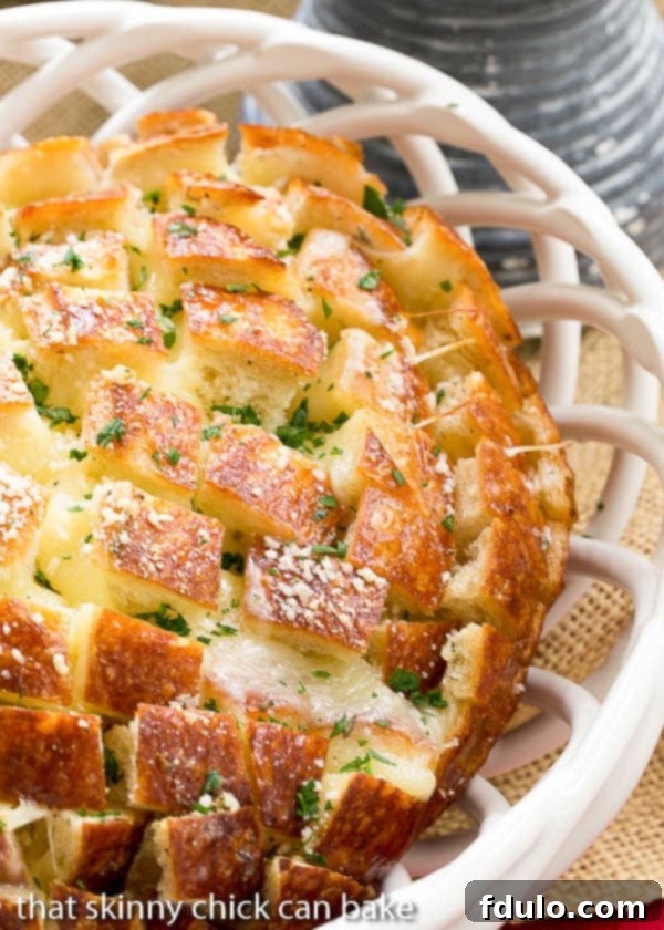 Close up view of Cheesy Garlic Bread in a white ceramic basket.
