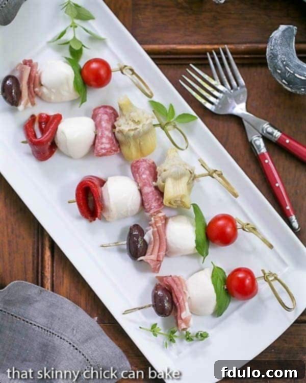 Antipasto Skewers - An easy twist on the Italian appetizer Antipasto Skewers on a rectangular white tray.