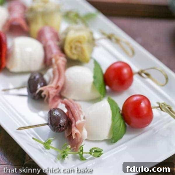 Antipasto Skewers - An easy twist on the Italian appetizer Close up of Antipasto Skewers on a white tray.