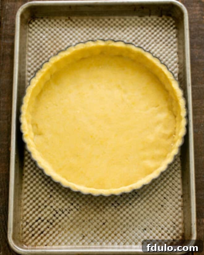 Step 5: Dough pressed evenly into a greased tart pan.