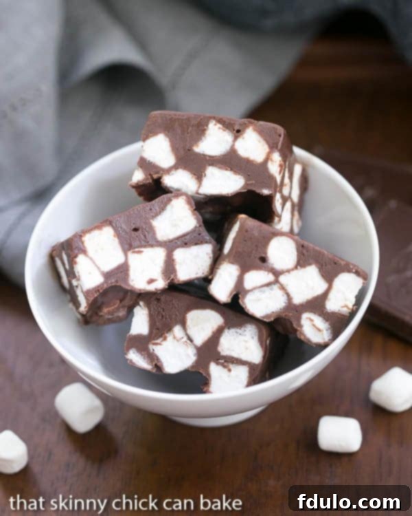 Dreamy Chocolate Marshmallow Fudge 2 Overhead view of several pieces of Chocolate Marshmallow Fudge arranged attractively in a white bowl