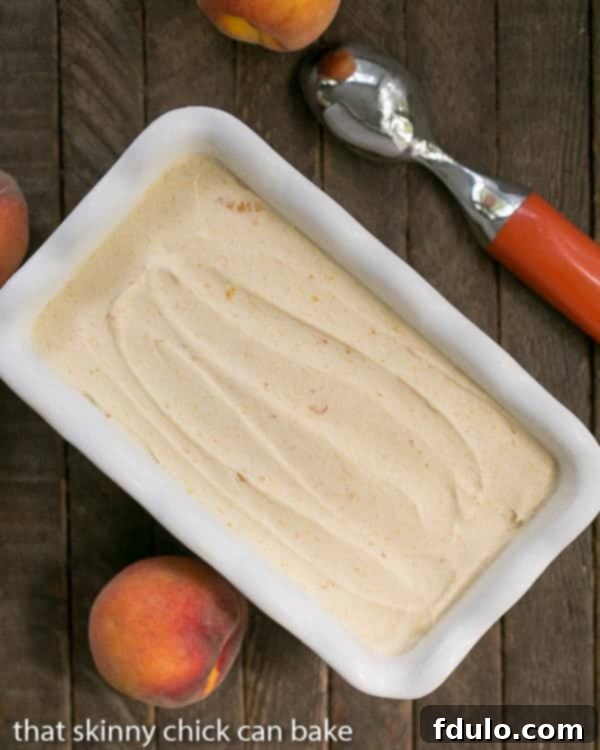 No Churn Roasted Peach Ice Cream in a white ceramic loaf pan