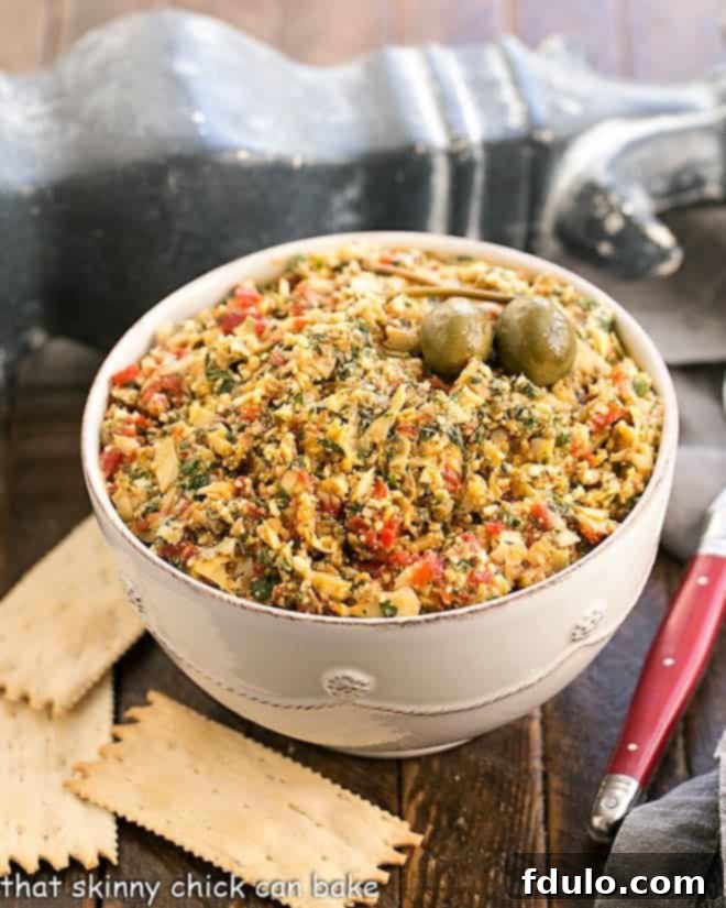 Roasted Red Pepper Artichoke Tapenade in a white serving bowl