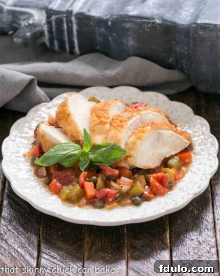 Beloved Chicken Dishes 10 Rustic Chicken Cacciatore stew, brimming with chicken, peppers, onions, and tomatoes, served in a deep bowl.