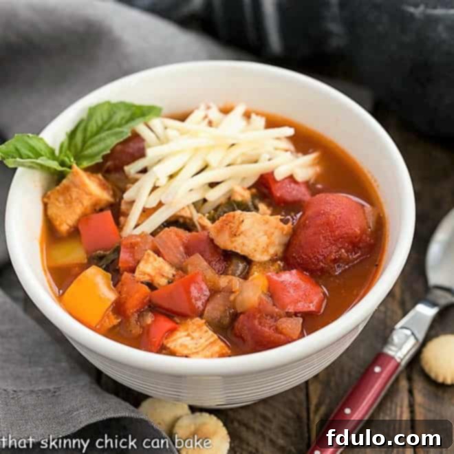 Beloved Chicken Dishes 15 Hearty Chicken and Bell Pepper Chili, garnished with cheese and green onions, perfect for a cozy meal.