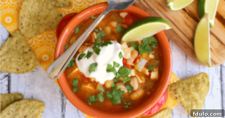 Beloved Chicken Dishes 8 Hearty bowl of Quick & Healthy Lime Chicken Chili, garnished with cilantro and a lime wedge.