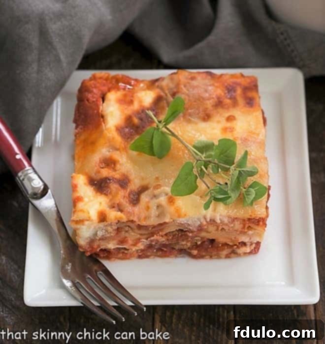 A slice of ricotta lasagna on a square white plate
