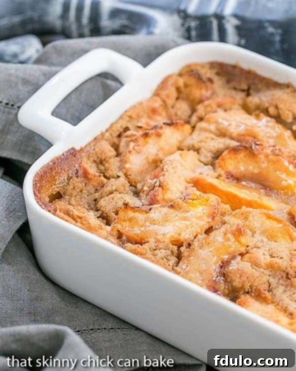 Fresh Peach Pudding - A self saucing peach dessert for a change from crisps and cobblers! Fresh Peach Pudding partial view in a white ceramic casserole, ready to be scooped.